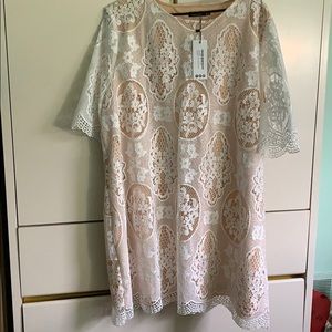 White lace shift boohoo dress with nude underlay.